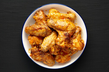 Homemade Rotisserie Chicken Wings with Smoked Paprika and Mayonnaise on a Plate, top view. Close-up.
