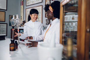 Obraz premium Cheerful multicultural scientists are working on a cure discovery in a vintage apothecary.