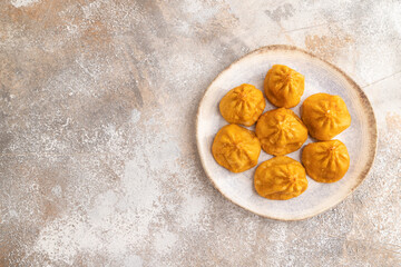 Manti dumplings on gray concrete. Top view, copy space.