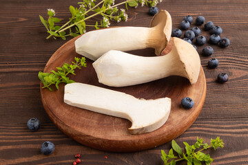 King Oyster mushrooms or Eringi (Pleurotus eryngii) on brown wooden. Side view.