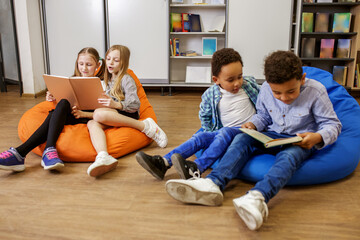 Children reading book in classroom. Back to school. Beginning of school lesson. break time