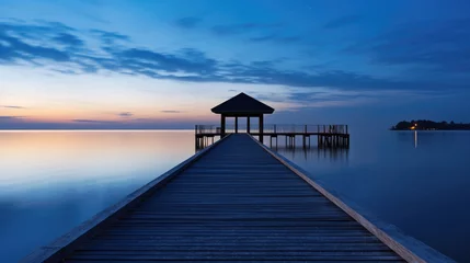 Poster Wooden bridge over the sea on blue hour. © visoot