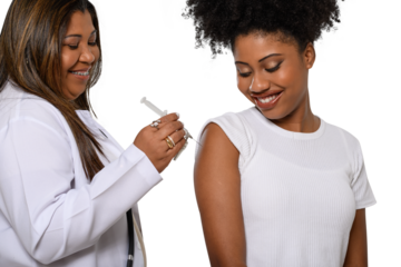  a health worker vaccinates a young girl, they are smiling.