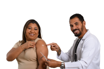 the doctor points to the vaccine sticker on the smiling woman's arm.