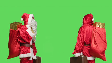 Saint nick with bag and suitcase carrying presents for christmas eve celebration, greenscreen...