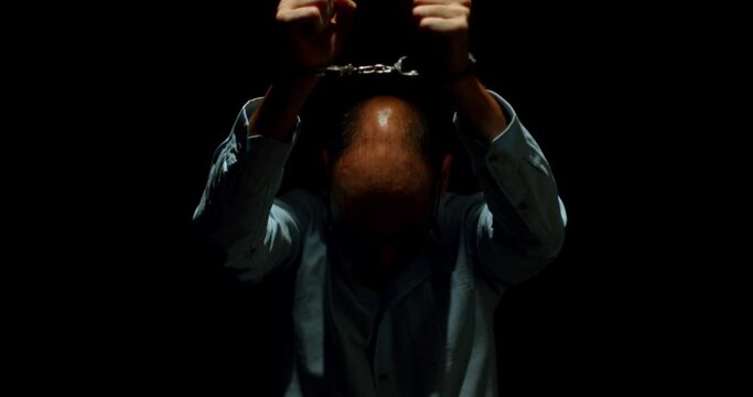 Captive Elegance. A Glimpse into the Despondency, Hopelessness, and Enigmatic Innocence of a Shackled Man in Corporate Attire.