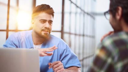 Doctor talking to a patient in a consultation at the office