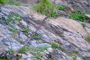 iron rusty cept on rock, difficult and dangerous part of path on route, Extreme hiking challenges, Treacherous trail sections, Wilderness journey difficulties