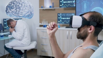 Experiment subject laying in lab bed wearing virtual reality headset, seeing holographic AR mind visualization while scientist monitors brain activity, contributing to neurology field development