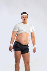Fototapeta na wymiar A funny fat man isolated on white background. Obesity and eating disorder. Concept for dietetics and fitness advertising in social networks.