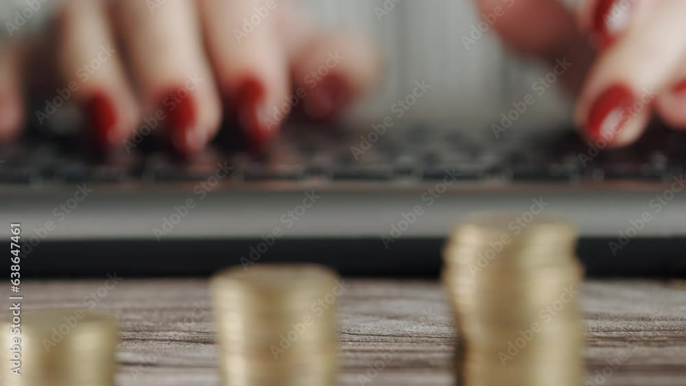 Poster the trader's hands are typing on the keyboard against the background of stacks of coins. the concept