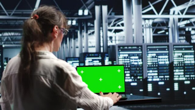 Certified IT programmer in server farm housing high end clusters capable of quickly and efficiently performing complex computations and data analysis, using mockup laptop to eliminate issues