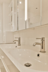 a white bathroom with two sinks and mirrors on the wall behind it is an image of a mirror above the sink
