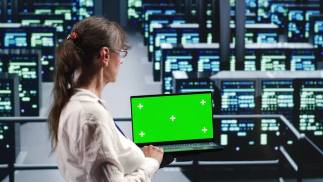 Licensed tech support in server farm housing high end supercomputers capable of quickly and efficiently performing complex computations and data analysis, using mockup laptop to remove dangers