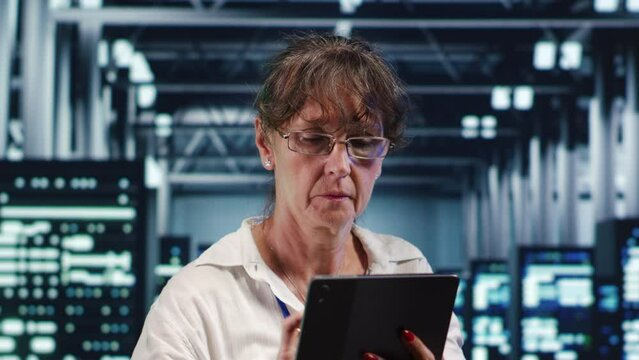 Data storage company executive working in workspace housing GPU dedicated servers that can process AI tasks with high efficiency, checking rigs used for machine learning showing drawbacks