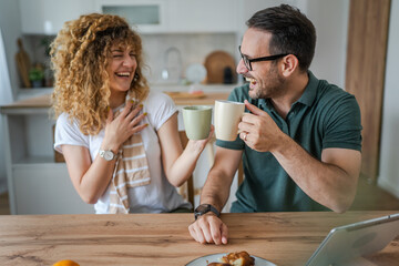 Young couple man and woman enjoy cup of tea or coffee in the morning