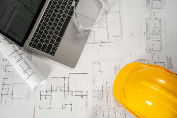 Man, architect, and engineer work discussing tools and construction concepts on a building site with blueprints for a professional construction job and building contractor development.