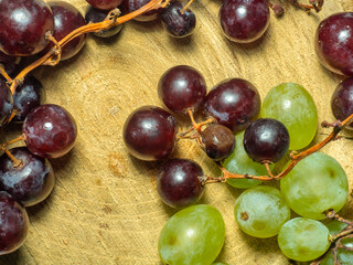 Grapes kishmish on a wooden background. The grapes are overripe. Harvest in the village. wine ingredient