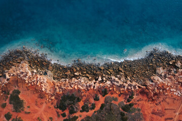 Aerial view of where the red dirt meets the ocean © seventysixtracks
