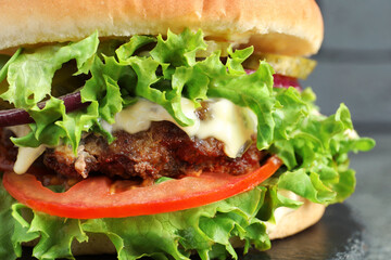 Delicious burger with beef patty and lettuce on table, closeup