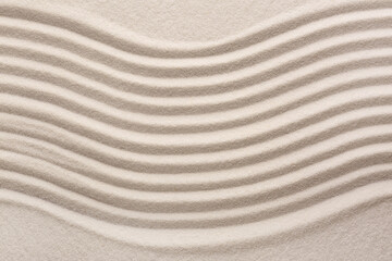 White sand with pattern as background, top view. Concept of zen and harmony