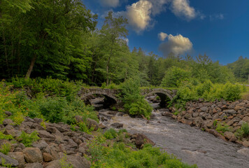 Fototapeta na wymiar Contoocook River in New Hampshire blue skies and green foliage surrounding the water
