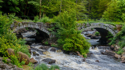 Contoocook River in New Hampshire blue skies and green foliage surrounding the water