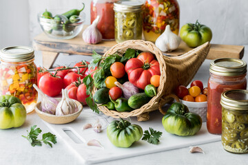 A cornucopia filled with vegetables with vegetable preserves and produce around.