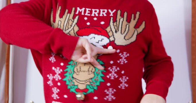 Festive finger dance. Man in ugly red sweater with reindeer is enjoying Christmas family party having fun dancing with his hands moving to beat of music. New year celebration musical congratulations