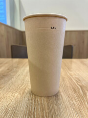 Paper Cup with Beverage on the Table in the Cafeteria