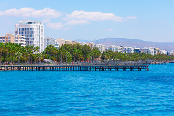 Palm trees and wooden pier in Limassol city, Cyprus