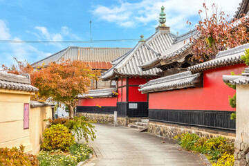 Nakatsu, Japan - Nov 26 2022: Goganji Temple (Red Wall Temple) established by daimyo Kuroda Yoshitaka and founded by the priest Kuyo, situated a little south of the center of the Tera-machi district
