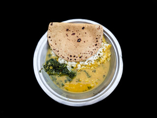 Indian delicious food rise with lentil daal and roti (bread) with black background 