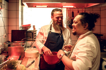 Young male chefs working in a japanese style sushi kitchen