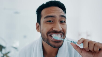 Face, man and brushing teeth in bathroom for dental wellness, morning routine and healthy gums. Portrait of happy asian guy cleaning mouth with toothbrush, toothpaste and care of fresh breath at home - Powered by Adobe