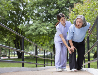 Senior adult Knee pain after practice walking practicing walking under the supervision of a nurse closely.In arthritis concept in seniors adult.