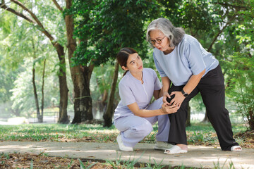 Senior adult Knee pain after practice walking practicing walking under the supervision of a nurse closely.In arthritis concept in seniors adult.