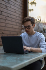 A student is working at a laptop in the park.