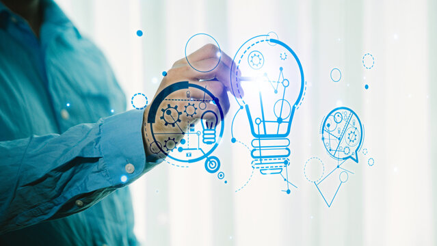 Businessman drawing a light bulb with a pen in a modern office