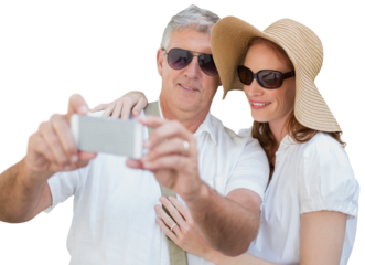 Digital png photo of happy caucasian couple taking selfie using smartphone on transparent background