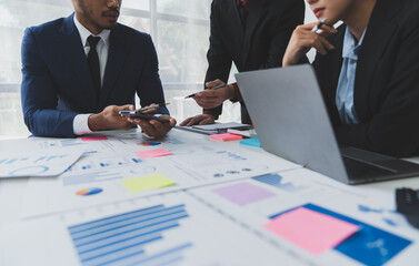 business professional Confident group of young business people analyzing strategies for brainstorming planning, calculations, data searching, idea presentation using laptop computers in the office.