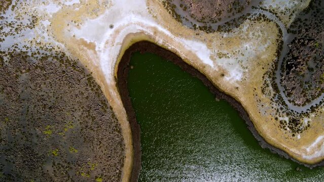 Aerial view over of Cotacotani Lagoon, Lauca National Park in Chile - top down forward, drone shot
