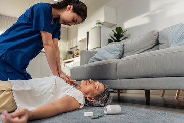 Asian caregiver saving senior woman's life by doing cpr in emergency. 