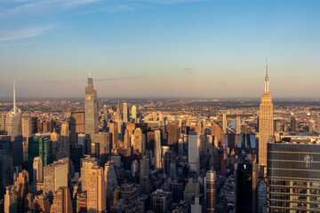 Captivating aerial view of New York City skyline during the dusk seen from The Edge. The buildings are shimmering with sunset colors. Endless rows of tall buildings. Bustling city. Endless horizon
