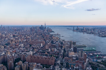 Captivating aerial view of New York City skyline over the Hudson River during the dusk seen from The Edge. Few white clouds above the city. Endless rows of tall buildings. Bustling and lively city