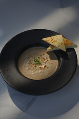 Mushroom Soup and Bread in a Black Bowl