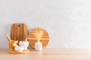Modern kitchen countertop interior in a minimalist style. two wooden cutting boards and mortars with a pestle. front view