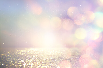 pastel background of abstract gold, pink and purple glitter lights. defocused