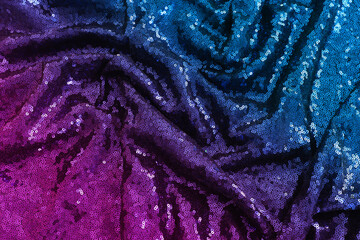 background of beautiful dark violet and blue sequins fabric