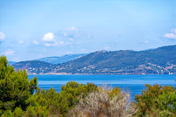 Fototapeta na wymiar Aerial view from Giens peninsula on a sunny spring day with Mediterranean Sea and mountain panorama in the background. Photo taken June 8th, 2023, Giens, Hyères, France.